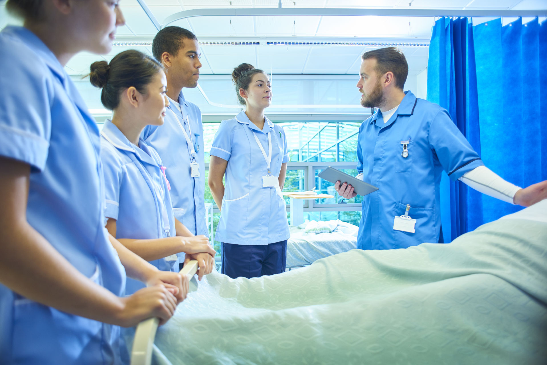image of students around hospital bed