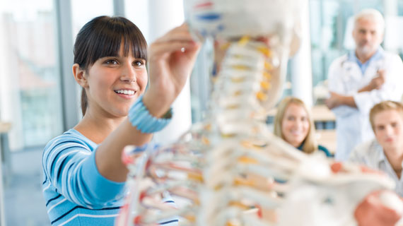 Photo of students with skeleton in foreground